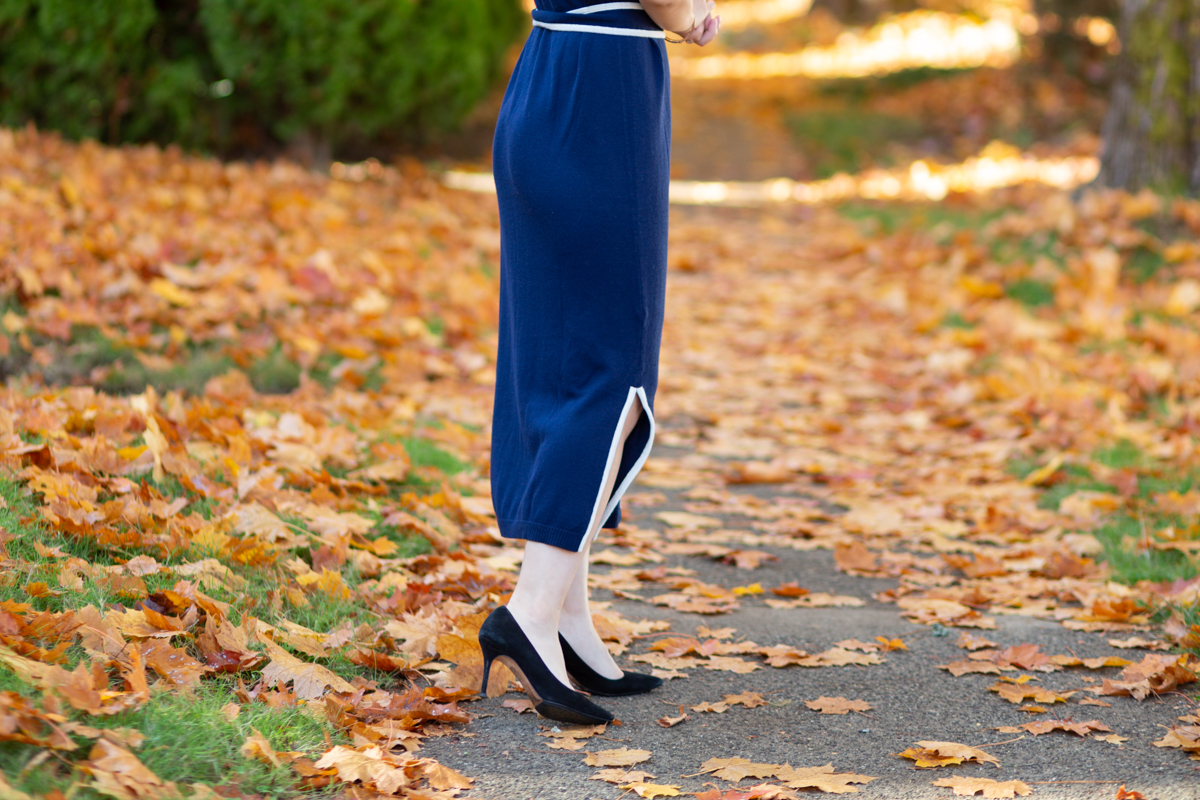 outfit of navy sweater dress with black suede pumps