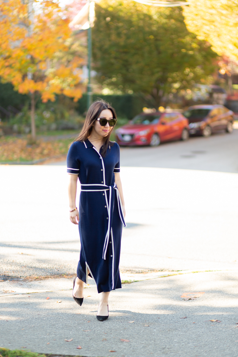Woman modeling navy sweater shirtdress from J.Crew with black suede pumps